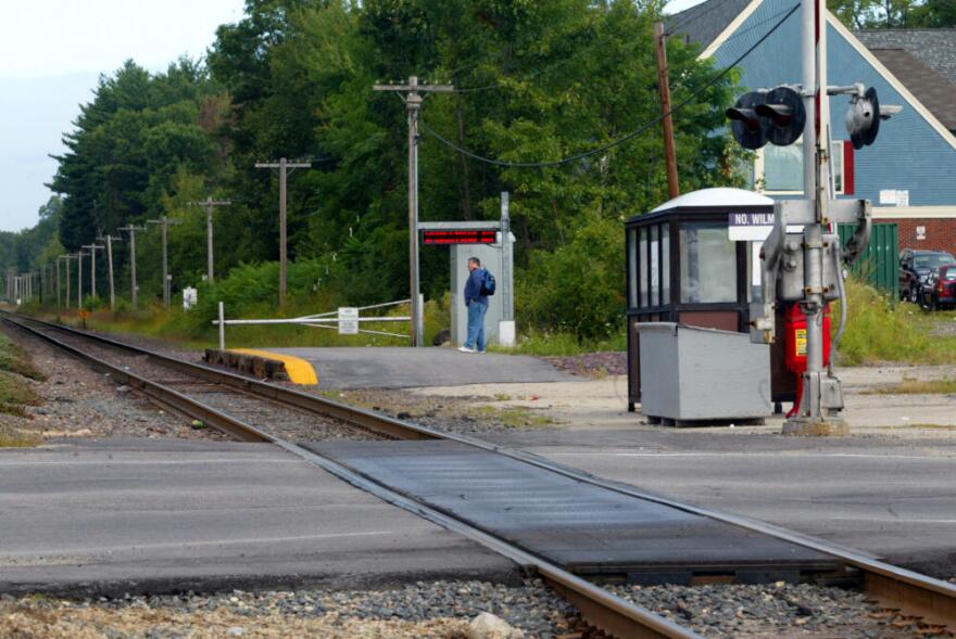 A commuter waits for the morning train at the North Wilmington stop on the Haverhill line. (Joanne Rathe/The Boston Globe via Getty Images)