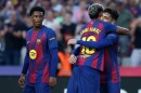 Barcelona's Lamine Yamal hugs Pedri after a goal during a La Liga soccer match between Barcelona and Girona in Barcelona, Spain, Saturday, Oct. 18, 2025. AP Photo/Joan Monfort)