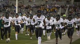 The Hawaiʻi team takes the field before an NCAA college football game against Nevada in Reno, Nev., Saturday, Oct. 16, 2021. (AP Photo/Tom R. Smedes)