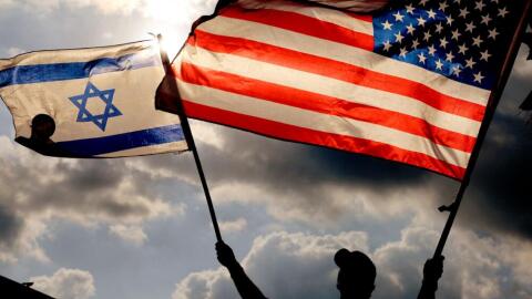 A protester waves U.S. and Israeli national flags on Sept. 20, 2023. (Jack Guez/AFP via Getty Images)