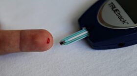 A patient with diabetes monitors his blood glucose with a glucometer. (Elmer Martinez/AFP/Getty Images)