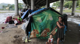 Hondurans left homeless by Hurricanes Eta and Iota last November living in tents on the only patch of dry ground they can find, under a highway in the northern city of San Pedro Sula.