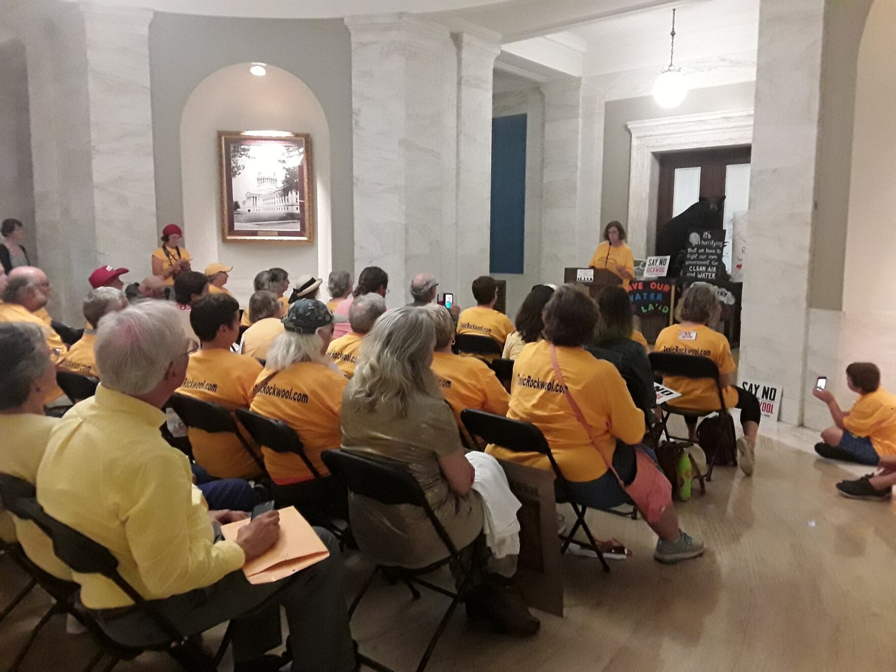 Catherine Jozwik, president of the Eastern Panhandle Green Coalition, speaks at a press conference outside the attorney general's office on Wednesday, June 19, before several residents and concerned West Virginians handed the governor's office a petition 