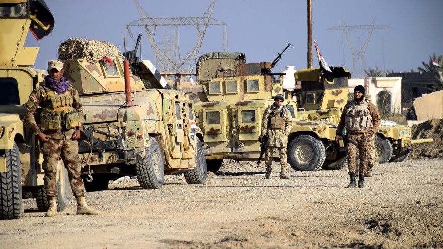 Iraqi soldiers advance their position in northern Ramadi, 70 miles west of Baghdad, on Monday.