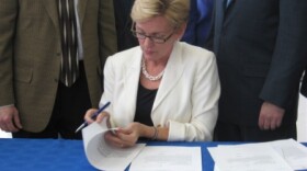 Gov. Jennifer Granholm signs the tax break bills.