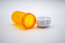 Empty orange medicine bottle with white cap isolated on white background.
