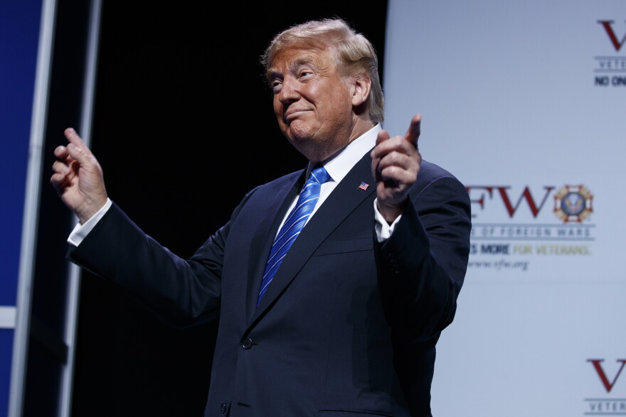 President Donald Trump gestures to music as he arrives to speak to the national convention of the Veterans of Foreign Wars, Tuesday, July 24, 2018, in Kansas City, Mo.
