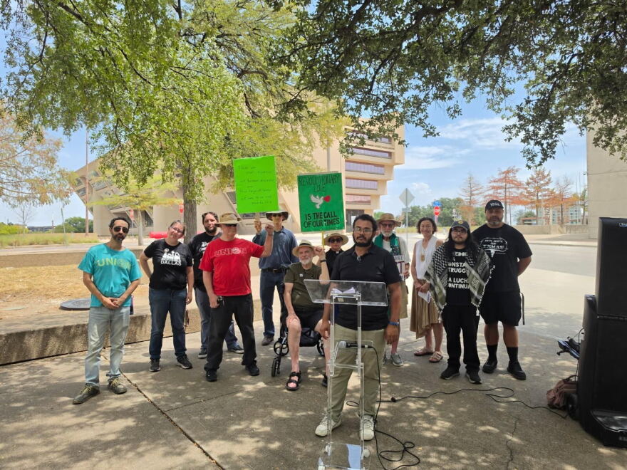 Supporters with the National Alliance Against Racist & Political Repression in Dallas stage their speech across the street from Dallas City Hall after being told to relocate.