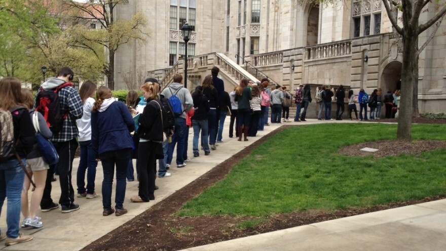 Students wait to pass through a security checkpoint at the University of Pittsburgh's Cathedral of Learning on Tuesday. Security has tightened at the school after a string of false bomb threats on the campus. 