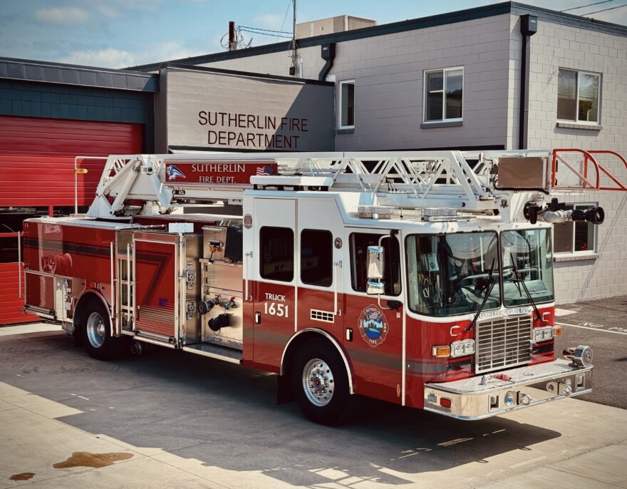 This ladder truck, Engine 1651, was purchased used for $750,000 using Public Safety Fee funds. Engine 1651, shown here in fall of 2025, carries structure firefighting tools and the 80-foot aerial ladder on top is used to flow water streams at large fires. It carries 400 gallons of water.