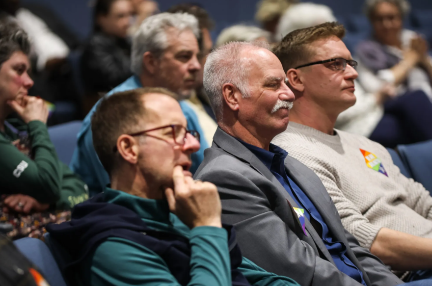 DeeJay Johannessen, CEO of the HELP Center for LGBTQ+ Health, center, sits in a City Council meeting Feb. 10, 2026, in Arlington. Johannessen told the council the resolution would’ve been a great statement of what the city is had it not come right after “stripping Arlington citizens of their basic civil rights.”