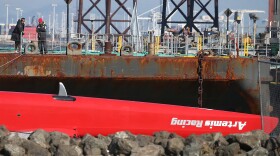 An upside-down hull of the Artemis Racing AC72 catamaran after being towed in to Treasure Island on Thursday.