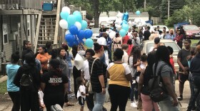 A crowd of mourners of all ages.