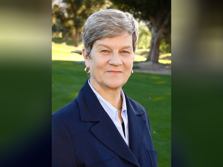 Portrait of Kathleen Hall Jamieson, wearing a blue blazer with a green park in the background.