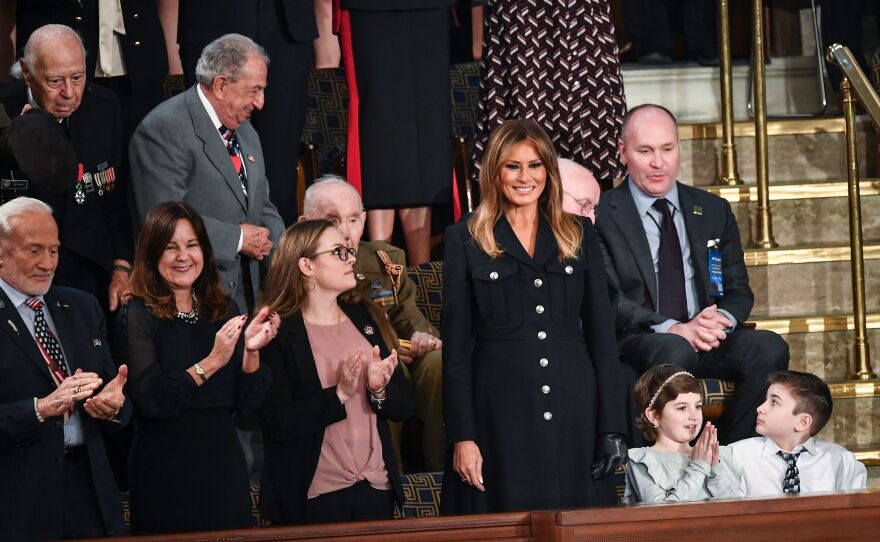 First Lady Melania Trump, center, is greeted, surrounded by special guests of the President.