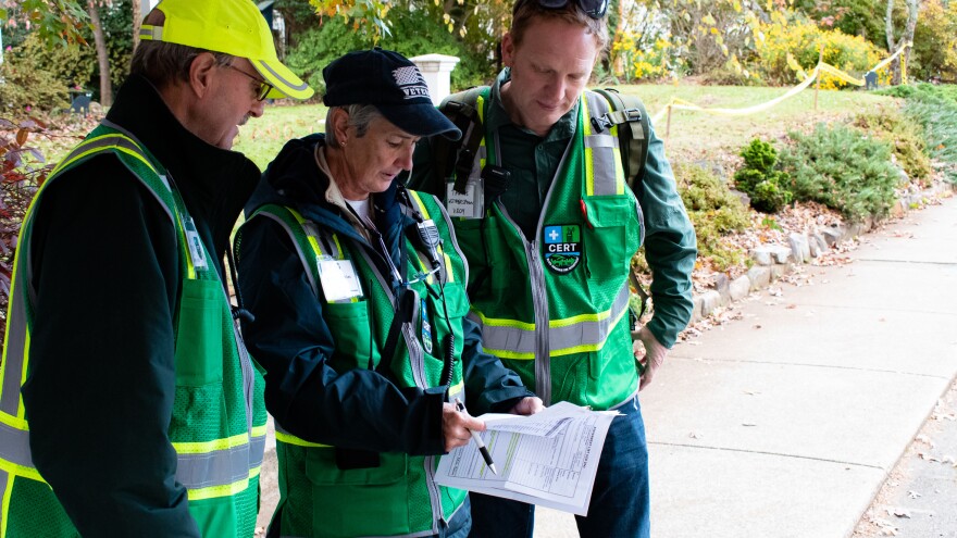 Volunteer Chris Kepler looks over the map of barricades and reunification tents that the group helped put together.