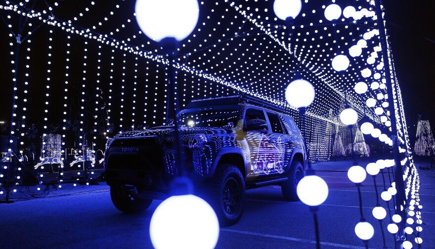 Grand Prairie has a new drive-through holiday light display. Here a family traverses the Light Park which features a 1-mile display synced to Christmas music that can be heard on a special station at Lone Star Park in Grand Prairie, Texas, Wednesday, November 10, 2021. Here (Tom Fox/The Dallas Morning News)