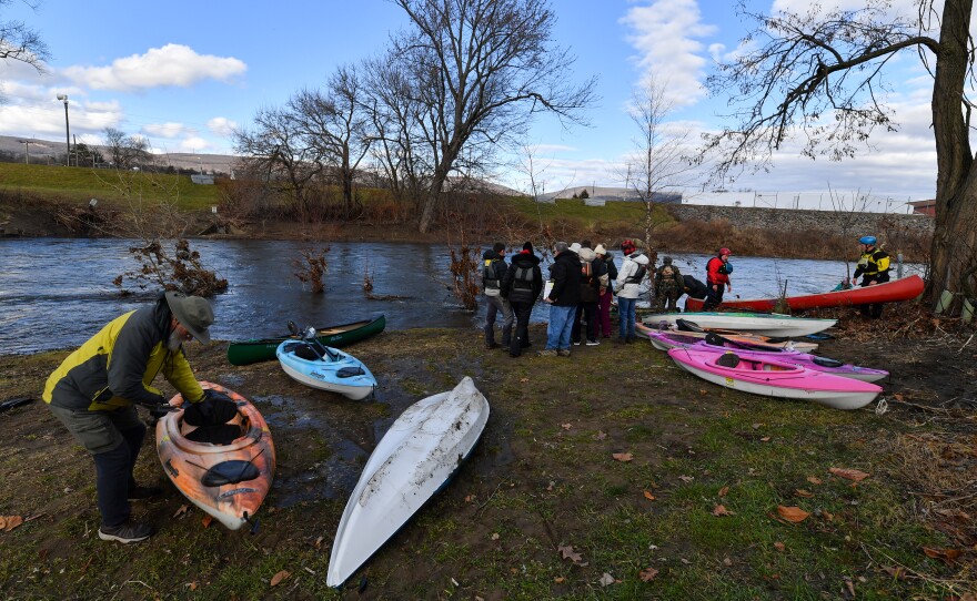 Paddlers pull their boats onto shore at Sweeney's Beach.