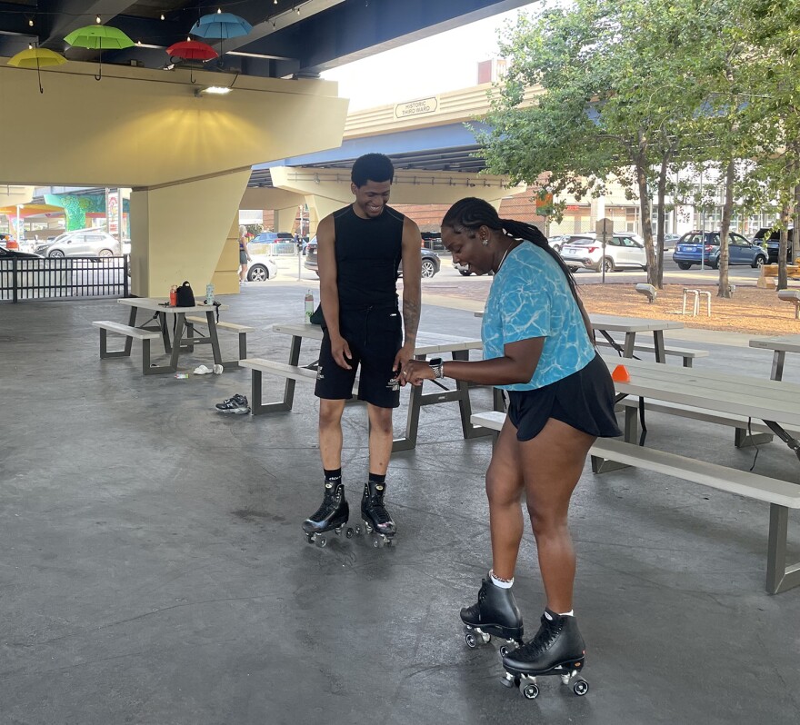 Arian Rice (left) teaching a lesson at Skate on 8's.