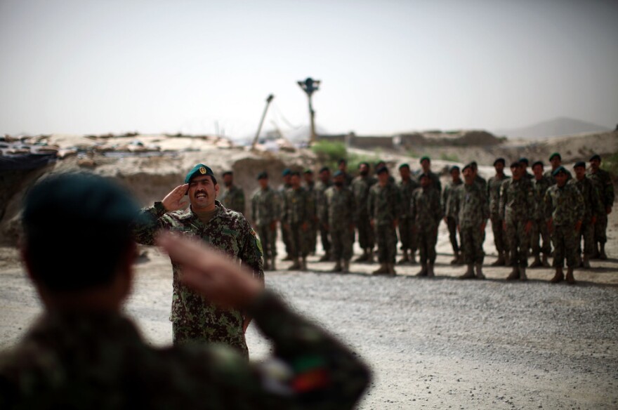 Brig. Gen. Ahmed Habbibi of the Afghan National Army salutes his soldiers in Panjwai district near Kandahar in southern Afghanistan.