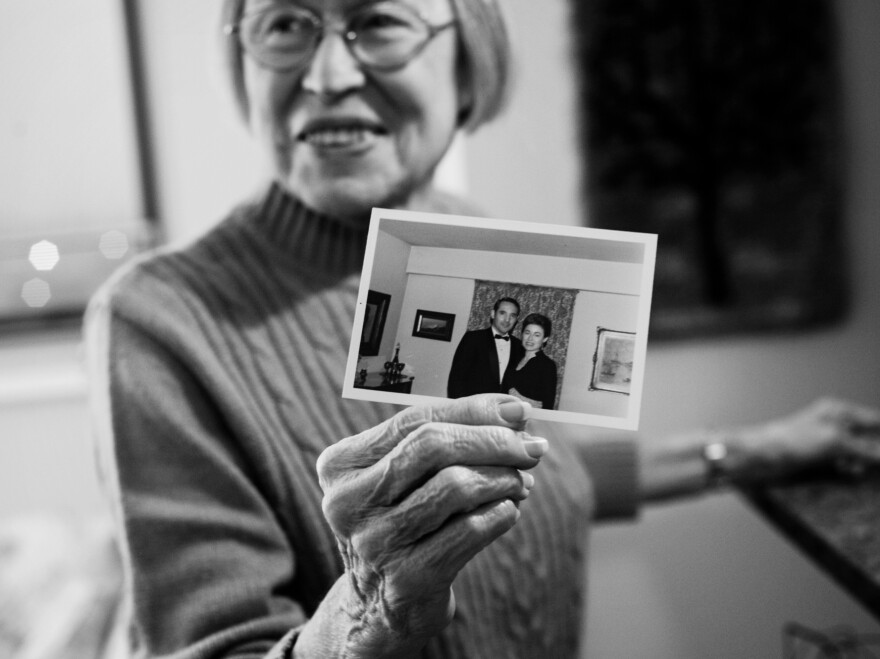 Lou Ann holds up photo of herself and Jay in their first apartment together in 1970.