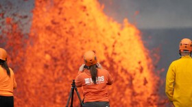 USGS Hawaiian Volcano Observatory scientists use laser rangefinders to estimate the height of lava fountains during Episode 49 of Kīlauea's eruption on June 14, 2026.