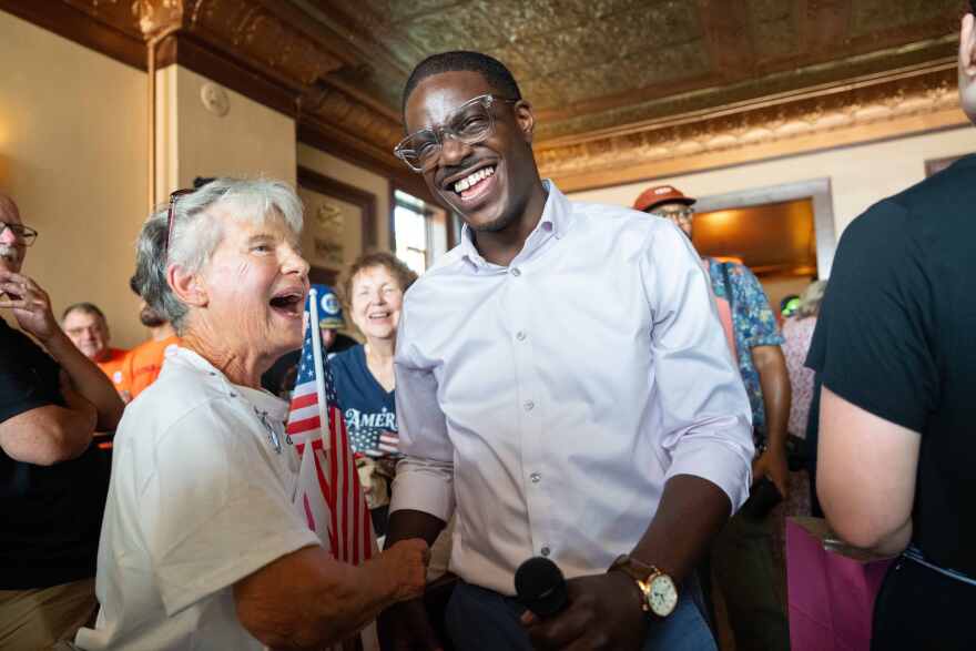 David Crowley, Democratic candidate for Wisconsin governor, shakes hands with Karen Hilt, left, during a campaign stop Friday, Aug. 7, 2026, in Sheboygan, Wis.