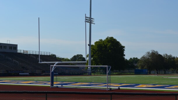A goal post sits at the end of a football field.
