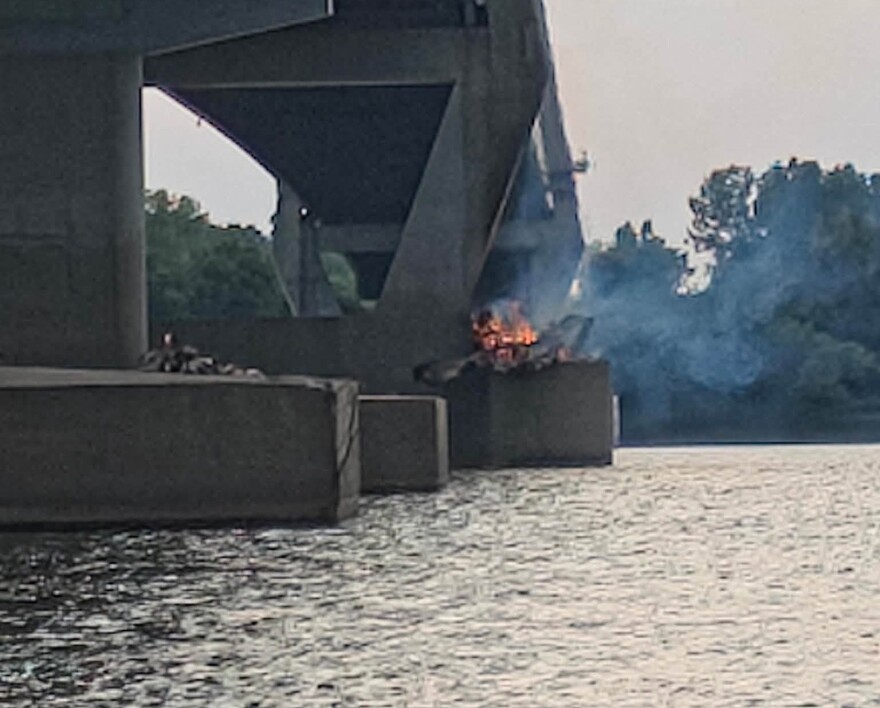 A fire burns under the William Natcher Bridge near Owensboro