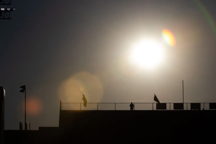 An intense sun beats upon Eastwood High School's stadium as a security guard stands on duty, Aug. 28, 2026.
