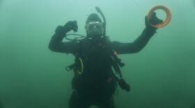 Diver Zach Talmadge holds on to the line that he'll use to attached to the abandoned lobster traps that he's found on the seafloor.