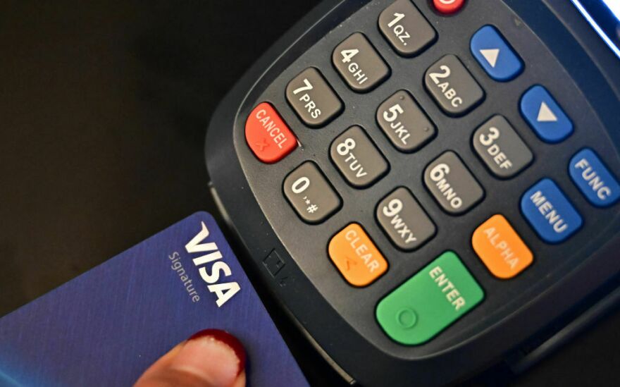 A credit card is placed into a machine for processing payments on Sept. 11 in La Puente, Calif.