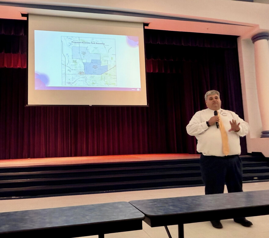 Stephen Ayres, the district’s director of student assignment and records, explains the proposed Wyomina Park rezoning during a presentation at Oakcrest Elementary. Ayres said Oakcrest’s academic improvement factored into the rezoning decision, adding, “The students are doing great.”