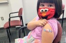 Annabelle Jimenez, a 5-year-old Hickory resident, shows off her Band-Aid after receiving a COVID-19 vaccine.