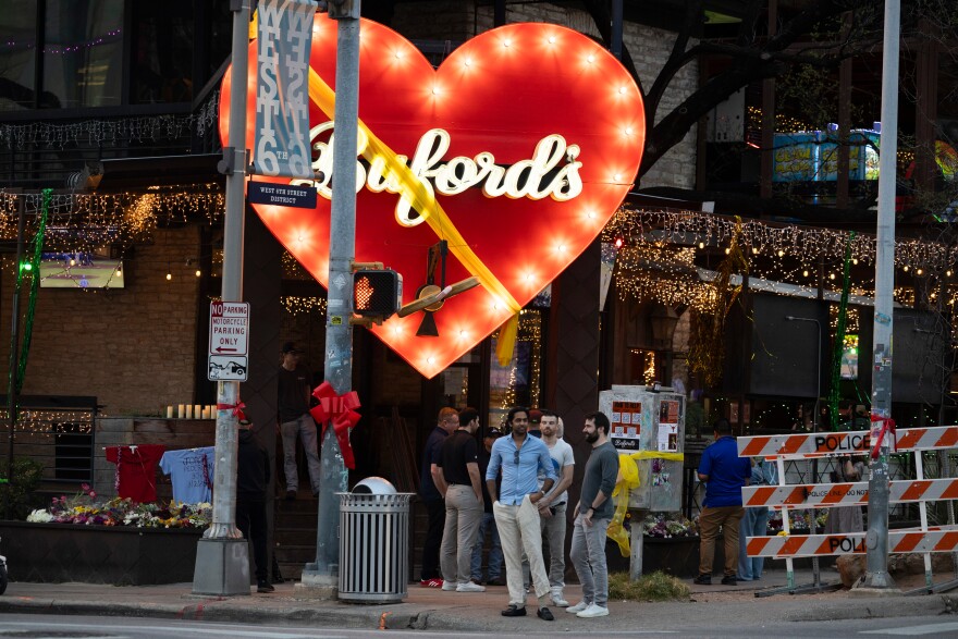 People gather outside Buford's on West Sixth Street as the bar reopened Friday, less than a week after a deadly shooting.