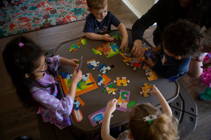 Children work on letter puzzles at Kid's Castle Family Daycare and Preschool in Pflugerville on Monday, Feb. 28, 2022.