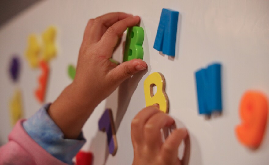 Children learn through play with magnetic letters and numbers at Fun Times With Titi Childcare on Monday, October 27, 2025.