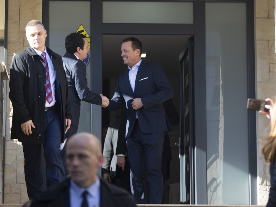 Albin Kurti (second left) shakes hands with U.S. special envoy for talks between Serbia and Kosovo Richard Grenell in Pristina on Jan. 23.