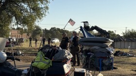 Oklahoma Highway Patrol troopers sweep an encampment on state property along Reed Avenue next to nonprofit Food and Shelter in Norman.