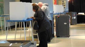 Voters fill out their ballots at the Children's Museum of Indianapolis Tuesday morning.