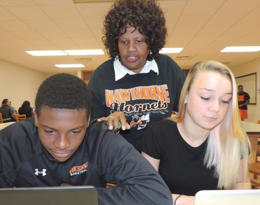 Angela Wright, a computer lab proctor at Hawthorne Middle/High School, works with students. Wright was named this week as one of five finalists for the Florida School-Related Employee of the Year Program award. (Photo courtesy Alachua County schools)