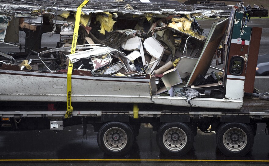 A damaged train car is shown on the bed of a truck along I-5 South on Tuesday, December 19, 2017, in Dupont. 