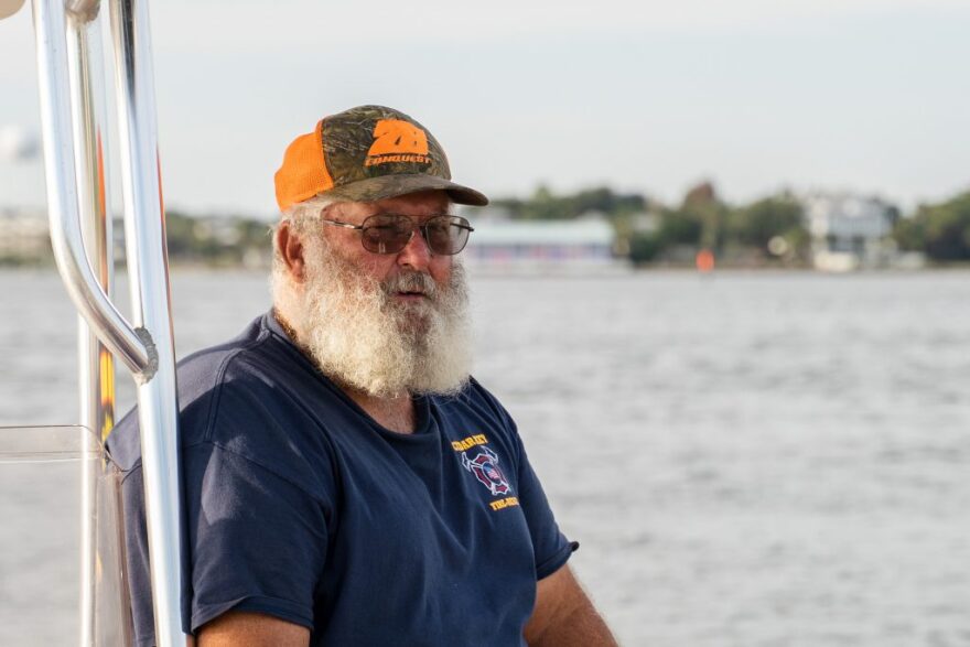 Man with a gray beard sitting on a boat