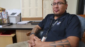 Micah Swimmer oversees a class of Eastern Band Cherokee language learners at the New Kituwah Academy in Cherokee, N.C. Behind him, a bulletin board displays the names of the few remaining fluent speakers of his Cherokee dialect.