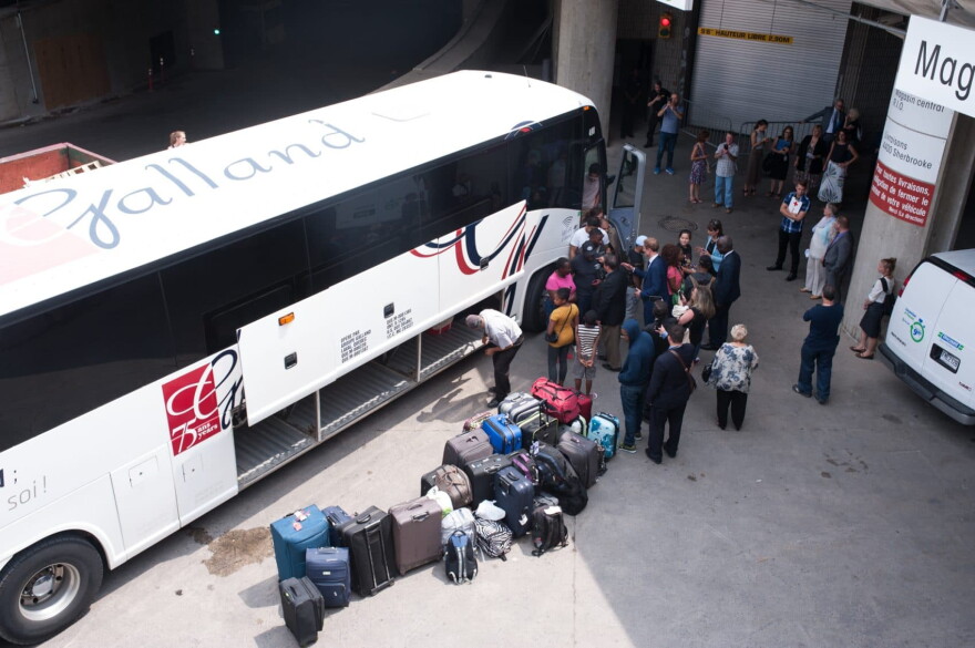 A bus of Haitian asylum seekers from the United States arrives at the Olympic Stadium in Montreal, Quebec, on Aug. 3, 2017. (Catherine Legault/AFP/Getty Images)