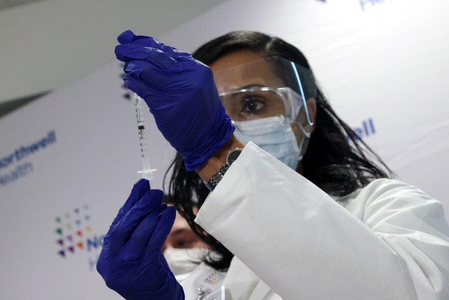 A medical worker at South Shore University Hospital gets ready to administer the newly available Johnson & Johnson COVID-19 vaccine in Bay Shore, N.Y., Wednesday. Clinical research found it to be 85% effective in preventing severe disease four weeks after vaccination, and it has demonstrated promising indications of protection against a couple of concerning variants of the coronavirus.
