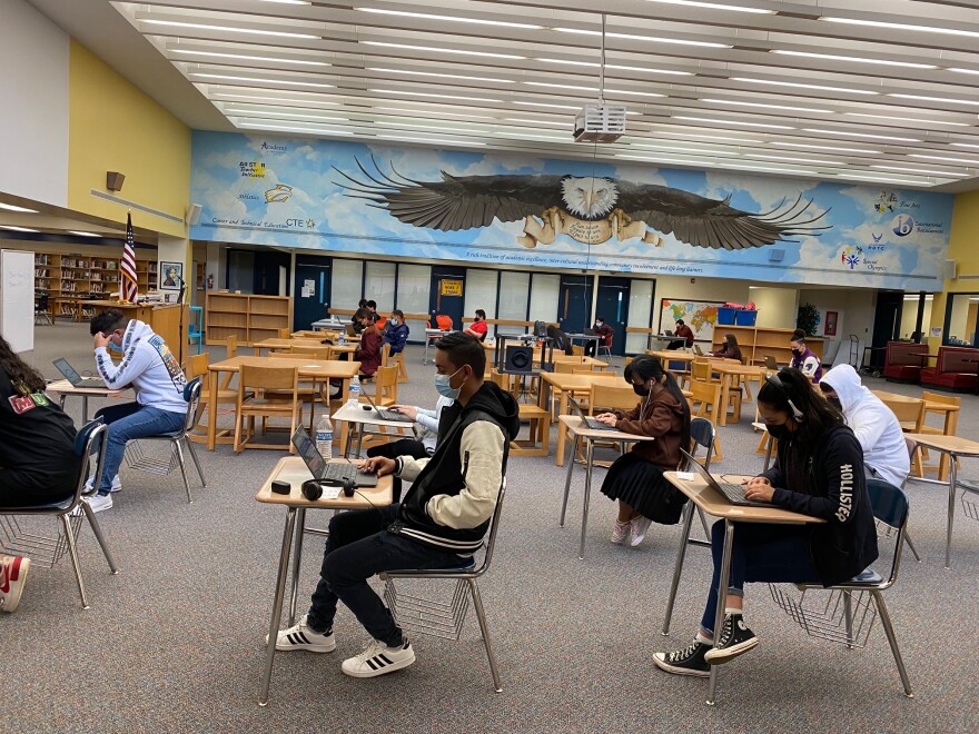  East Mecklenburg High students taking tests in the school media center.