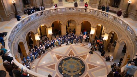 Children and parents from Annunciation School sing Feb. 24, 2026, inside the Capitol during a rally urging lawmakers to pass gun safety measures.
