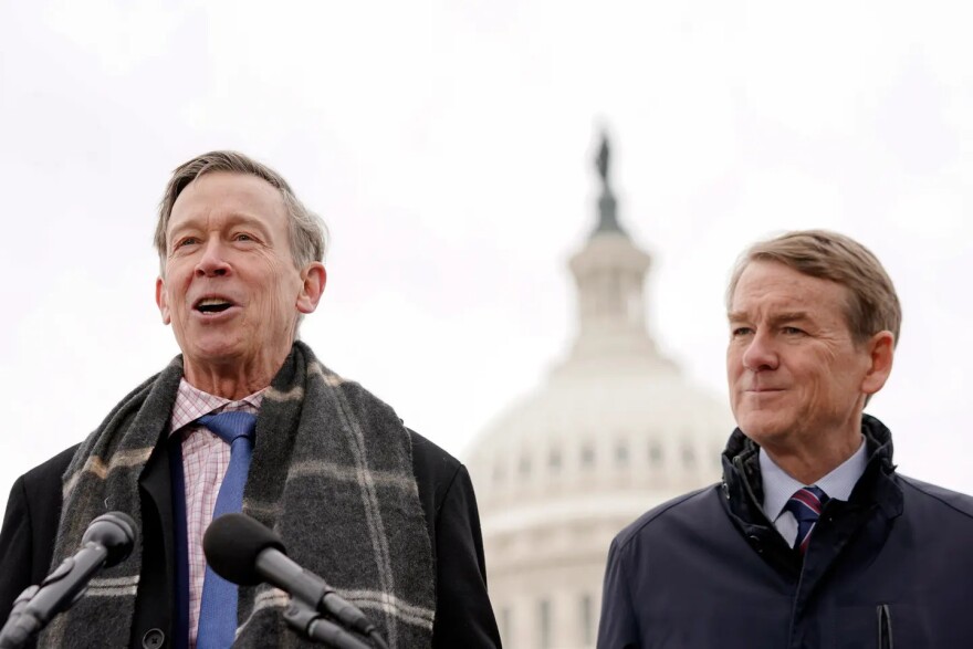 Sen. John Hickenlooper, D-Colo., left, speaks at a news conference on Thursday, Jan. 18, 2024, at the U.S. Capitol as Sen. Michael Bennet, D-Colo., right, listens, in Washington, D.C.