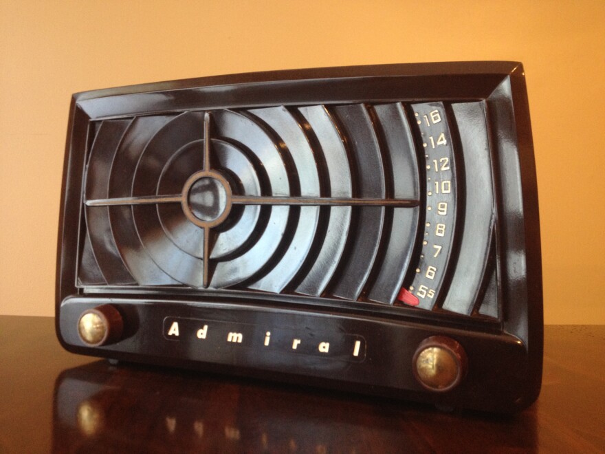 Photograph of a brown table top radio made by Admiral. The design of this vintage Bakelite tube radio is known as a bullseye, because the cabinet resembles a bullseye.  